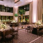 Reception tables at a wedding at The Langham Chicago showcasing XL tall planters throughout the room.