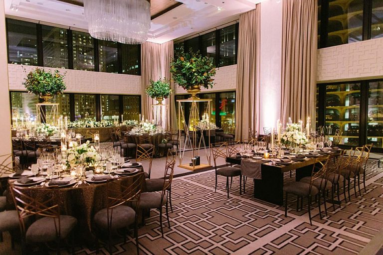 Reception tables at a wedding at The Langham Chicago showcasing XL tall planters throughout the room.